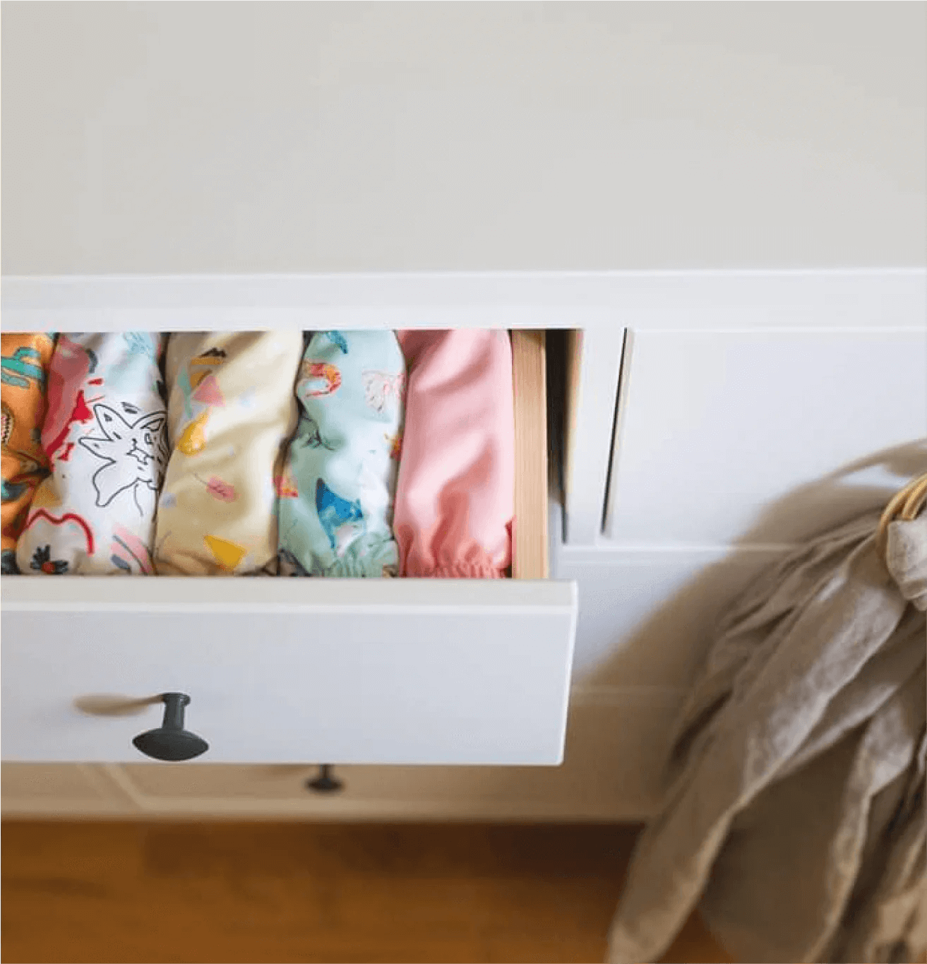 cloth diapers lined up in a drawer